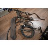 A WWII cable laying harness and stirrup pump