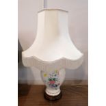 Large table lamp and shade with floral decorated ceramic base,