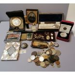 Collection of coins, travel clock, card case, silver topped smelling salt bottle,