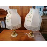 Pair of decorative table lamps, each with brass effect column, alabaster base and floral shade,