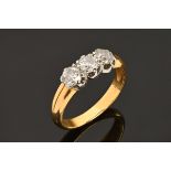An 18 ct yellow gold three stone diamond ring, size P/Q.