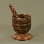An antique Treen pestle and mortar, with moulded and carved decoration.
