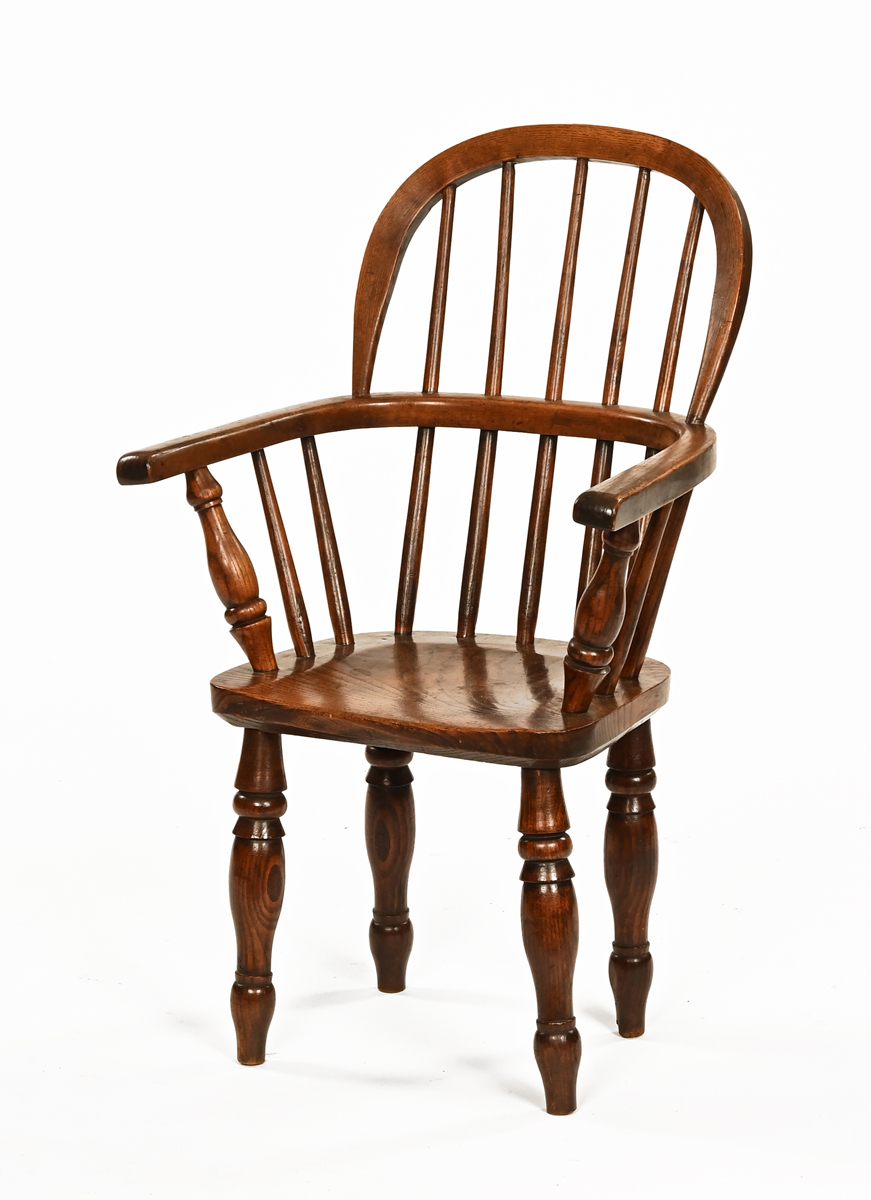 A 19th century ash and elm child's Windsor chair, with solid seat and turned legs.