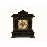 A late Victorian ebonised mantle clock, on square dial and two train striking movement.