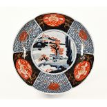 An Imari bowl, of shaped circular outline decorated in typical Imari colours. Diameter 24.5 cm.