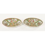 A pair of 19th century Cantonese oval dishes, decorated in typical Canton colours. Width 25.5 cm.