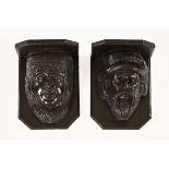 A pair of Tudor style oak carved corbels of a man and a woman, each 30 cm high.