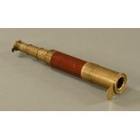 A 19th century brass and mahogany three drawer telescope. Length extended 70 cm.