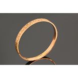 A 9 ct rose gold bangle, with engraved foliate decoration, S Ward & Sons Chester 1925. 10 grams.