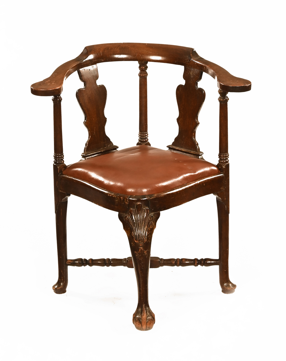 An early 18th century walnut corner or writing armchair, with double splat back,