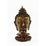A Thailand bronze Buddha, raised on a carved hardwood stand, possibly 18th century.