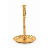 A 19th century Dutch brass candlestick, with sliding ejector and circular base. Height 38 cm.