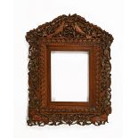 A 19th century Anglo Indian carved hardwood mirror or picture frame,