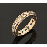 A gold coloured metal diamond set eternity ring. Size N.