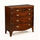 A George III mahogany bowfronted chest of drawers, two short and three long,