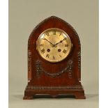 An Edwardian mahogany mitre topped mantle clock, with two train striking movement.