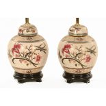 A pair of ginger jar form crackleware table lamps, each raised on a wooden base.