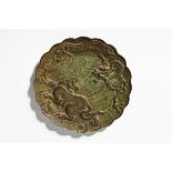 An antique Chinese signed bronze plaque, decorated with dragons. Diameter 22 cm (see illustration).