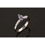 An 18 ct white gold ring, set with a pear shaped tanzanite and diamonds to each shoulder.