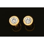 A pair of 14 ct gold diamond stud earrings +/- .5 carats.