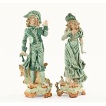 A pair of French porcelain figures, principally blue. Height 33 cm.