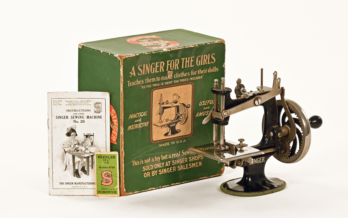 A vintage boxed Singer sewing machine, "A Singer For The Girls".