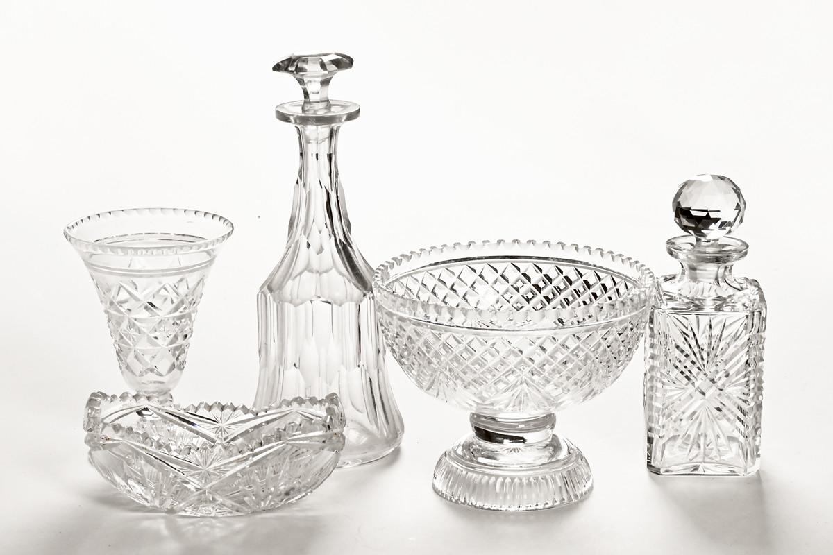 A cut glass fruit bowl, two decanters, vase and bowl.