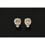 A pair of 18 ct white gold stud earrings, set with diamonds weighing +/- 2.21 carats.