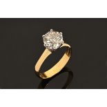 An 18 ct gold two tone solitaire ring, set with a diamond weighing +/- 2.10 carats.