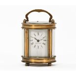 A small brass carriage clock, oval in plan, timepiece only. Height excluding carrying handle 7.