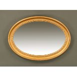 An early 20th century bevelled glass oval mirror with gilt frame. 66 cm x 90 cm.