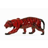 A Royal Doulton Flambe model stalking tiger, with Doulton mark to front foot. Length 35 cm.