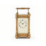 An Edwardian brass carriage clock, timepiece only with column corners and raised on short bun feet.