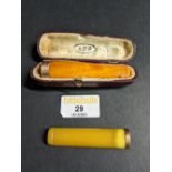 Two 9 ct gold and amber style rimmed cheroot holders