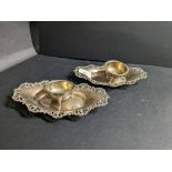 Two Birmingham silver stamped dishes with scrolled borders and pair of Birmingham silver salts,