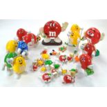 A quantity of M&M Plastic Figures in various sizes including dispenser issues. Some a little grubby.