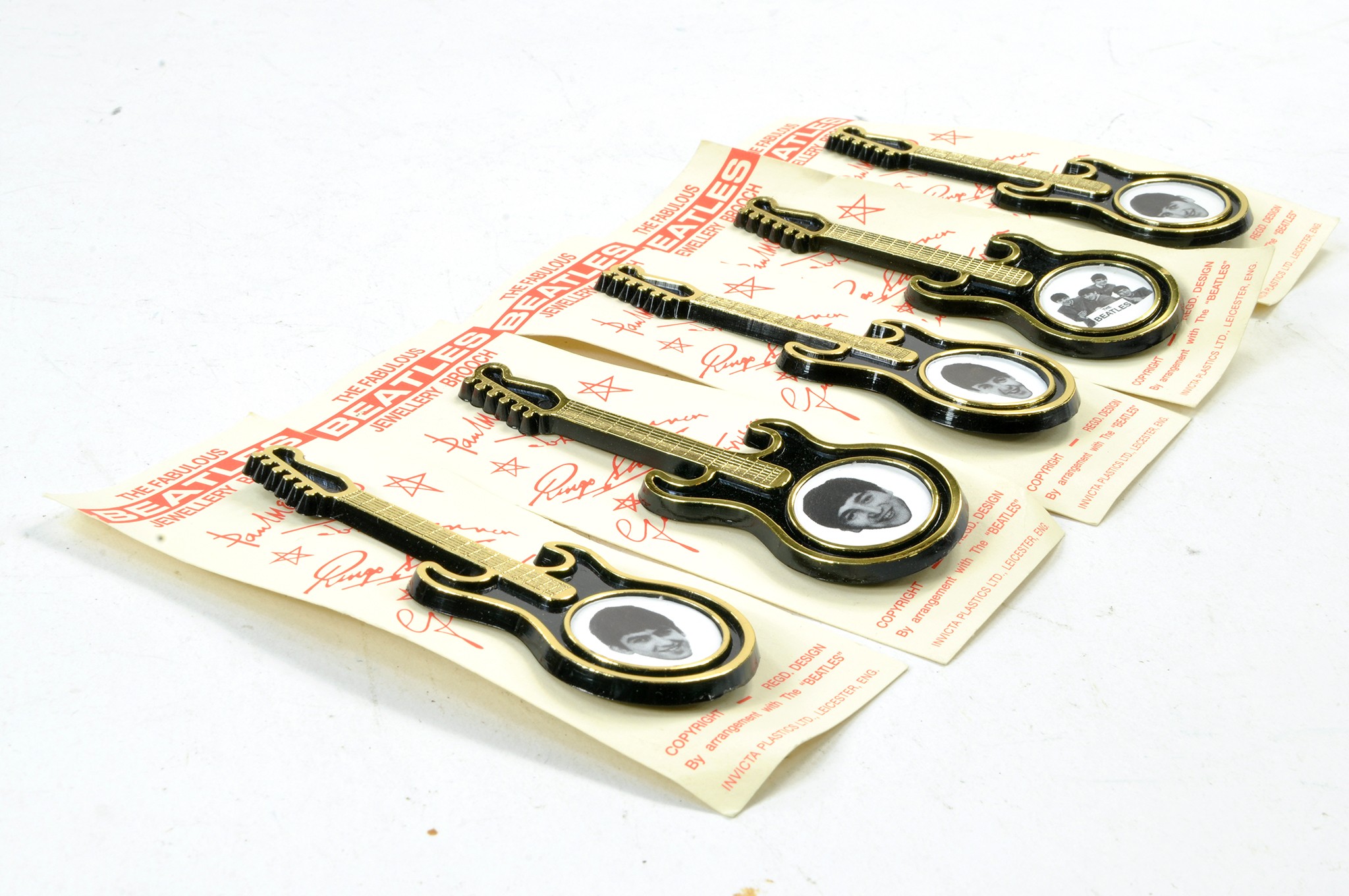 Beatles set of Five Guitar Brooch issues featuring band members on four and one group image on the