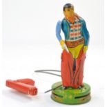 Attractive Tinplate Cowboy with Gun, and remote plastic cable gun. Non functional but toy still