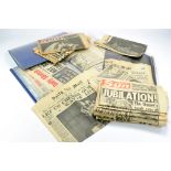 A box containing a few dozen old newspaper relating to significant events including Moon Landing,
