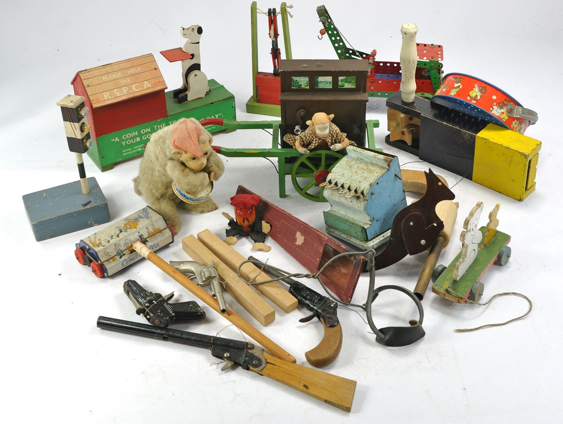 An assortment of well loved vintage toys and games including Meccano, various toy guns and