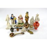 An intricate group of antique collectables comprising ornate figurines and bygones, including