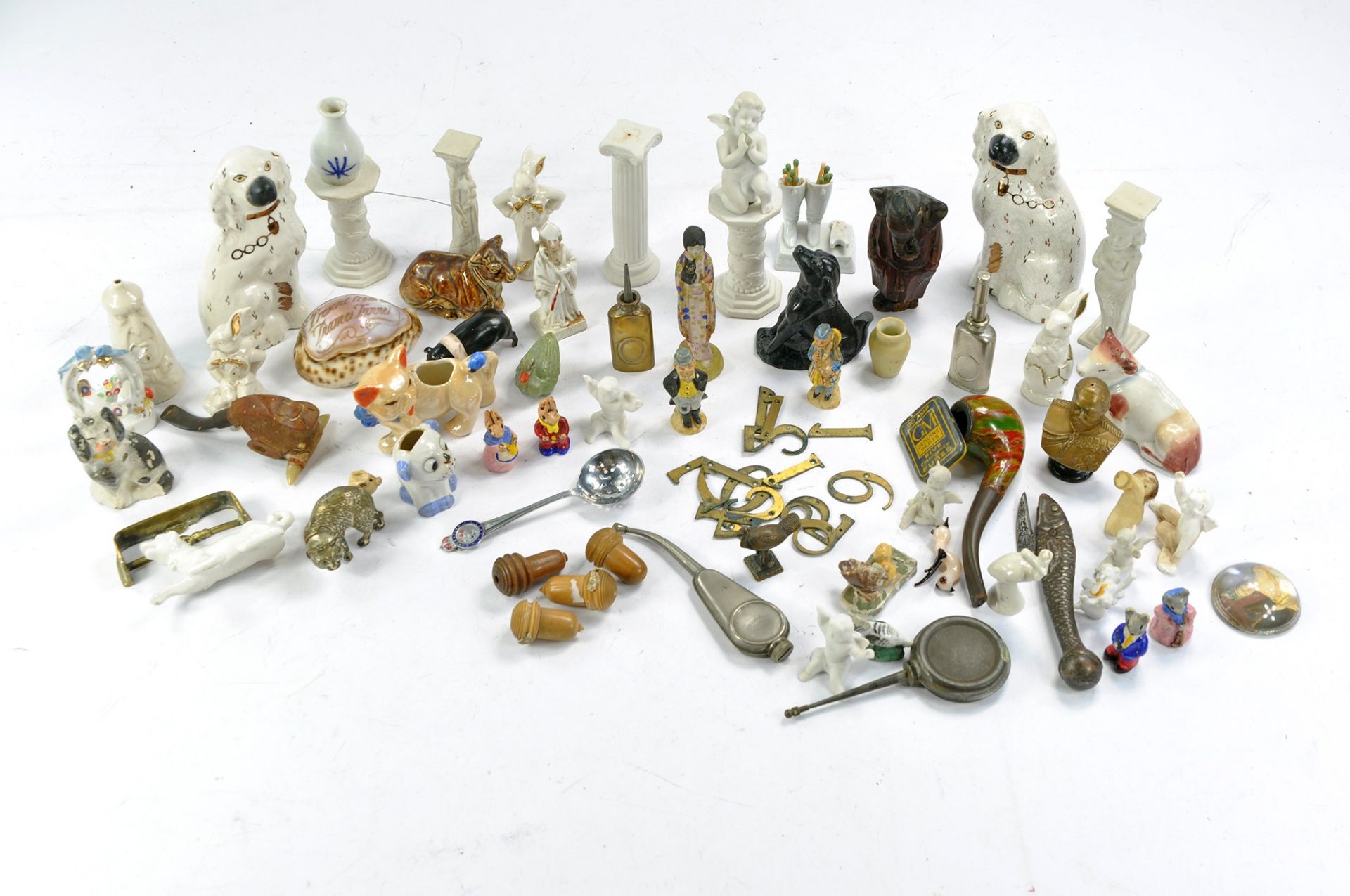 An eclectic group of vintage and antique miniatures comprising ceramic, metal and wooden themes.