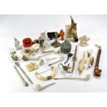 A group of varied and vintage smoking pipes, some with fine detail comprising ceramic, wooden and
