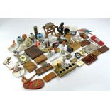 A varied array of miniature vintage bygones to include several tins and boxes of various theme in