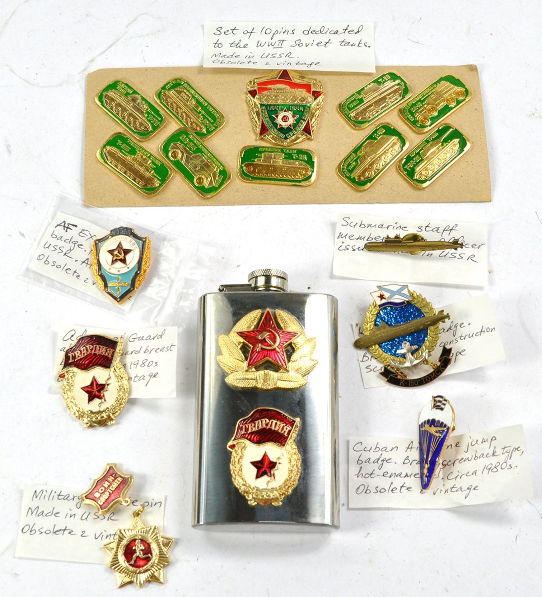 A group of vintage Soviet Military Badges plus CCCP engraved hip flask.