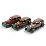 Dinky No. 30d Vauxhall Saloon. Trio including two earlier variations. Matt and Gloss brown finishes.