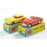 Corgi No. 218 Aston Martin DB4 Duo. One is red with lemon interior, spun wheels, the other is yellow