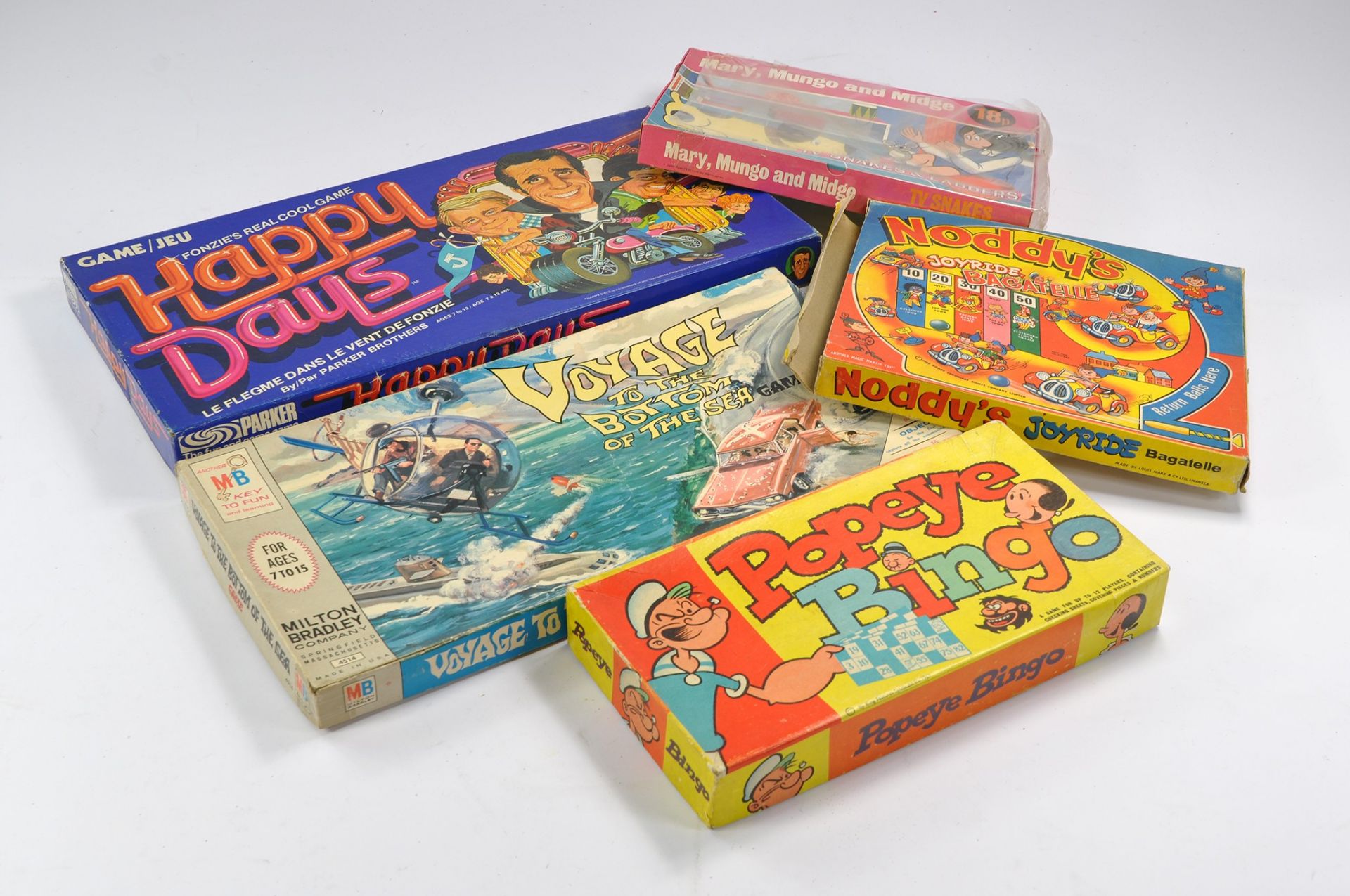 An assortment of harder to find vintage games and toys including Happy Days, Voyage to the bottom of