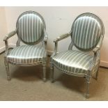 A pair of early to mid 20th Century painted spoon back salon elbow chairs in the Louis XV style