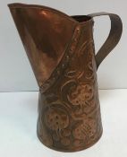 A large Newlyn School type tapered jug with pomegranate decoration and wide handle and spout,